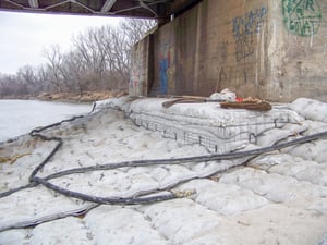 An AB mat extends out from a bridge - one of the most commonly overlooked types of structures when it comes to scour.