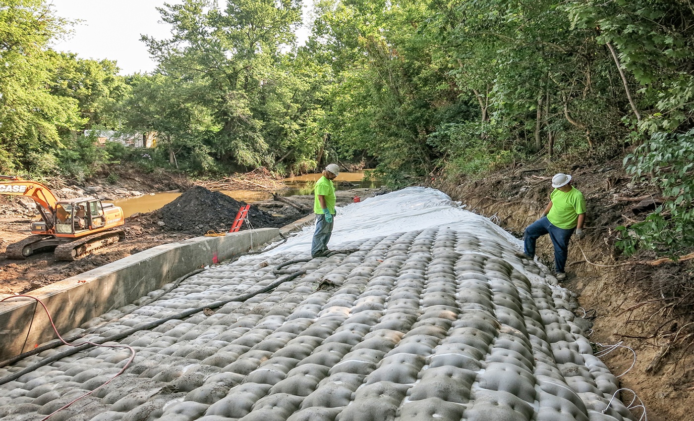 Nelosca crew members installing scour remediation AB mat.