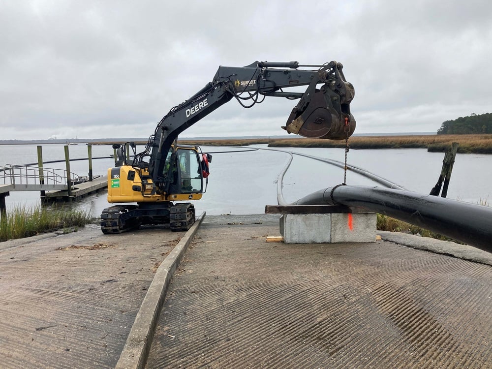 Excavator Holding Pipe