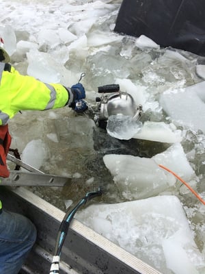 Our diver navigates under thick ice for a client