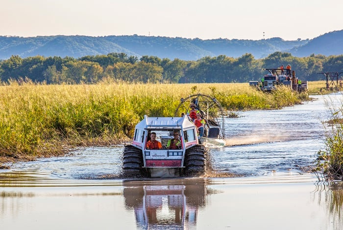 Sherp ATV and Airboat behind it onsite