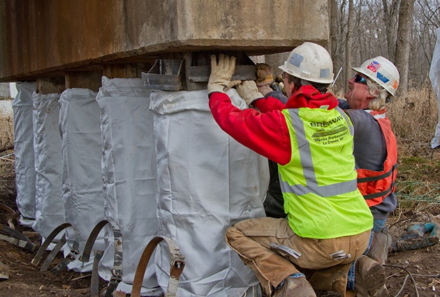 pile jacket repairs, railroad bridge pier repairs, pile jackets, fabric formed pile jackets, pier restoration, bridge construction, railroad bridge construction and repair